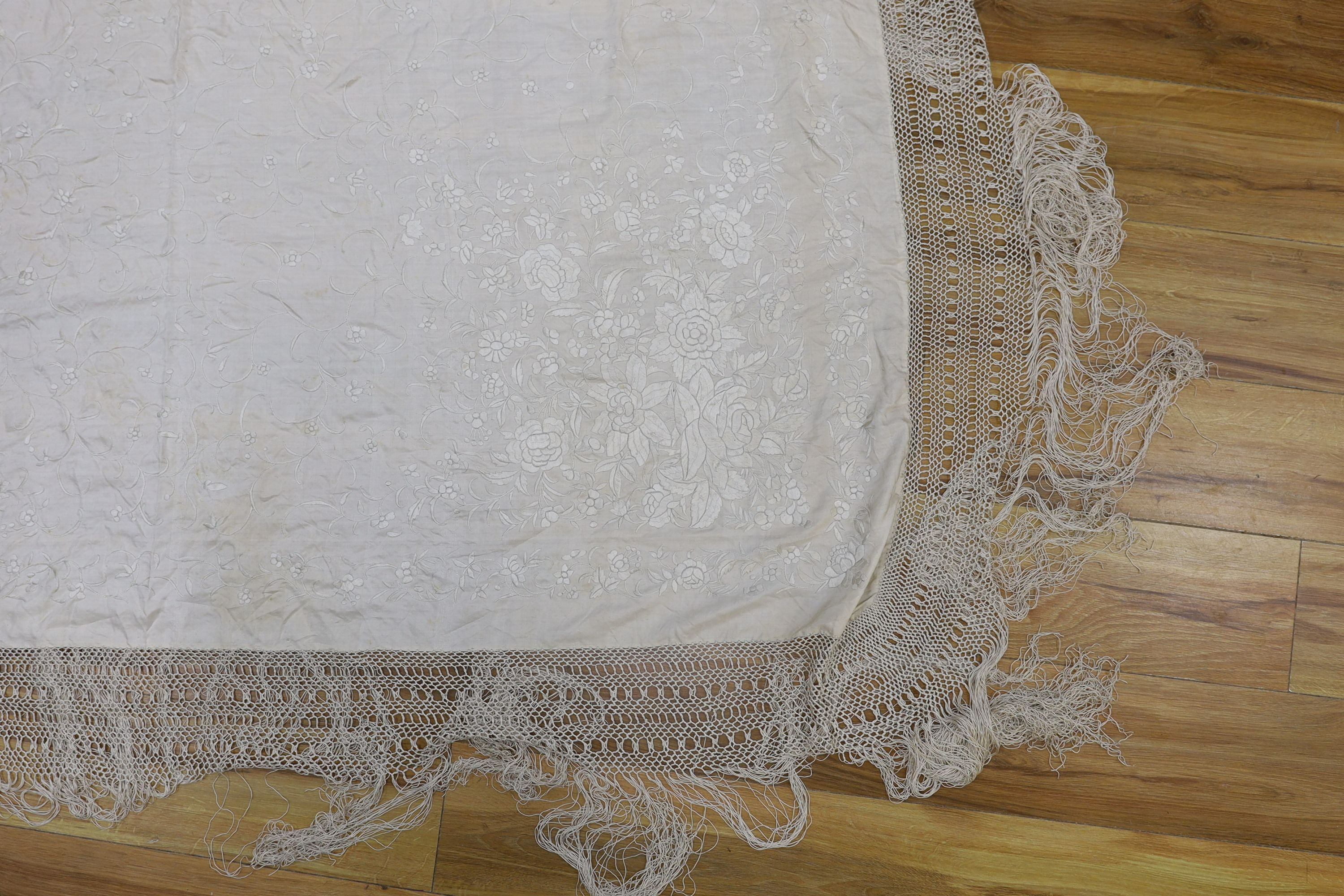 A 19th century cream embroidery on cream silk shawl together with a smaller later shawl